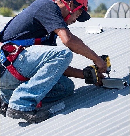 commercial roofer repairing a business roof