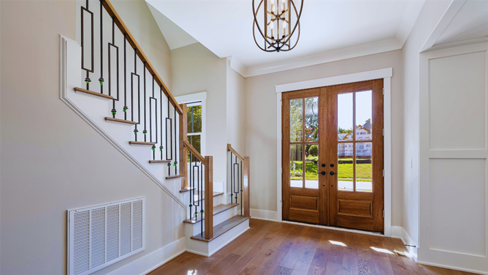 Modern front door with decorative glass panels and a brushed nickel handle installed by a trusted NJ Door Replacement Company.