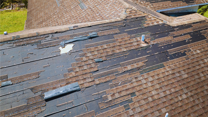 A roof with shingle missing after a storm with high winds in NJ.