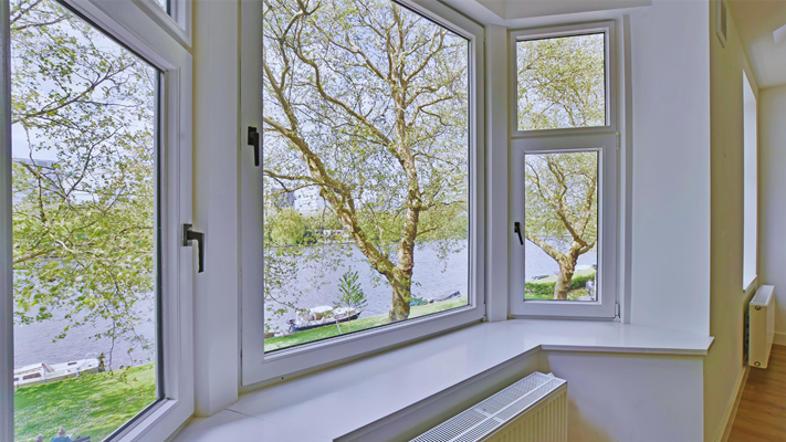 A NJ window replacement looking out over a river with boats. 