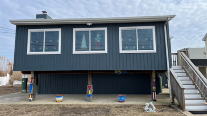 A NJ home with new blue replacement siding.