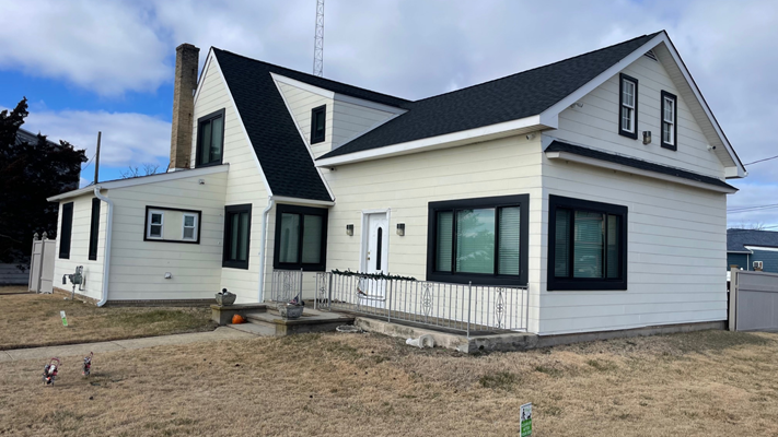 Image of a modern home with professionally installed gutters, highlighting their importance in preventing water damage to the roof and siding.