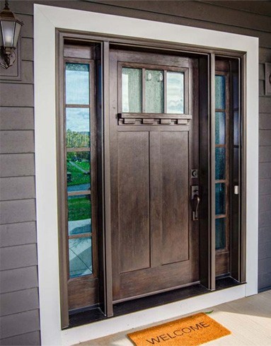 Stained wood front door by residential door installers